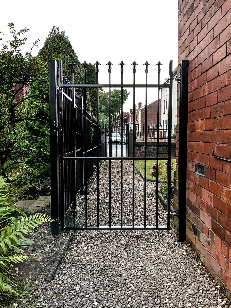 ColourRail Gate — ornate railing gate beside a terrace