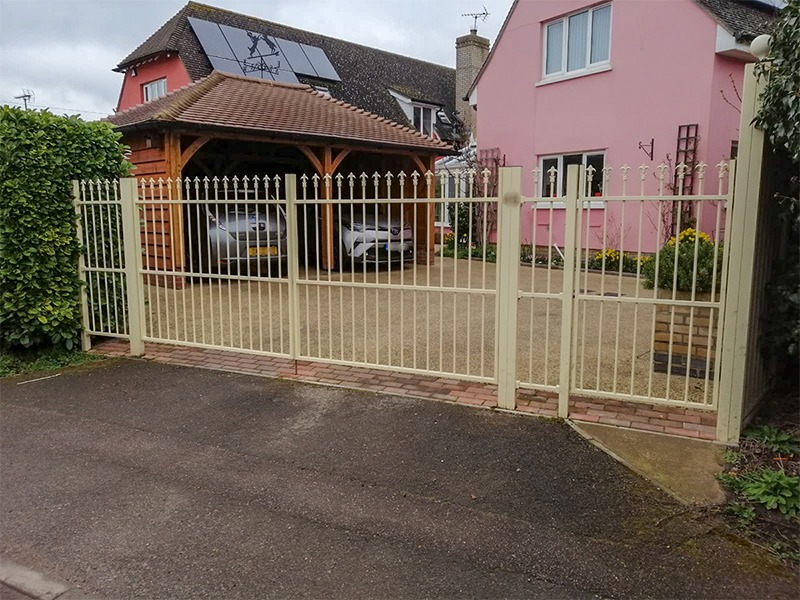 Black steel trellis gate with climbing plants